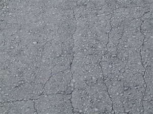 Photo showing fine longitudinal hairline cracks running parallel to one another with only a few interconnecting cracks. The cracks are not spalled.