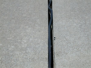 Close-up photo of a transverse joint with high-severity joint seal damage.  The joint in the photo is fairly wide, and the sealant is noticeably debonded from both sides of the joint.