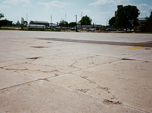 Overview photo showing a slab that is broken into more than five pieces. The cracks that divide the pieces are a combination of medium- and high-severity cracks.