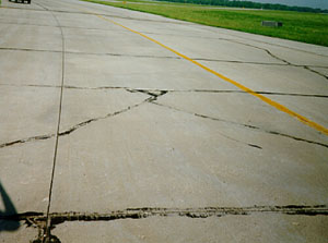 Overview photo showing a slab that is broken into four or five larger pieces. The cracks that divide the pieces are low-severity cracks.