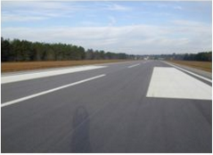 This picture shows an asphalt runway pavement with no distress.  The PCI of the pavement in the image is 100.